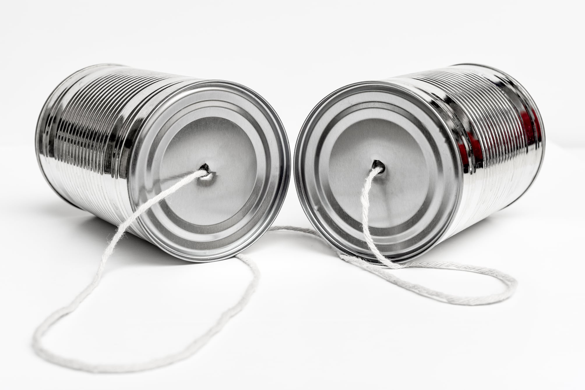 cans tied together with string suggesting talk to us
